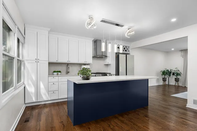 a kitchen with stainless steel appliances granite countertop a sink stove and wooden floor