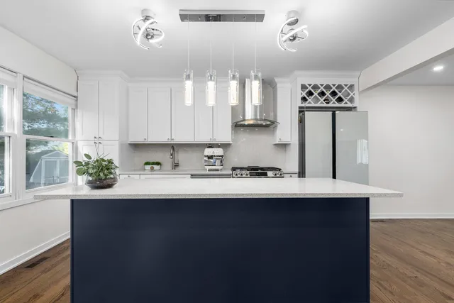 a kitchen with a sink a window and cabinets