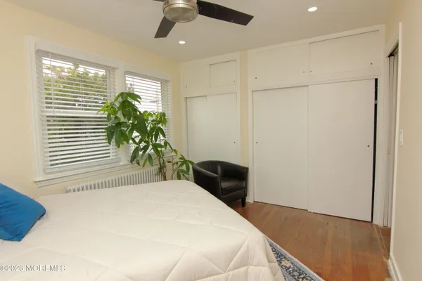 a bedroom with a bed and a potted plant