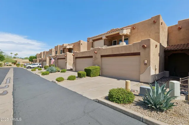a view of a backyard with sitting area