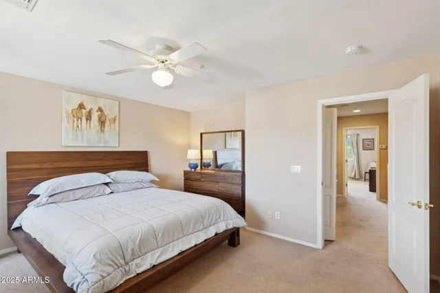 a view of a living room with a floor to ceiling window and wooden floor