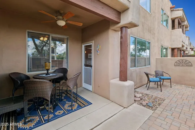 a living room with kitchen island furniture a chandelier and a dining table