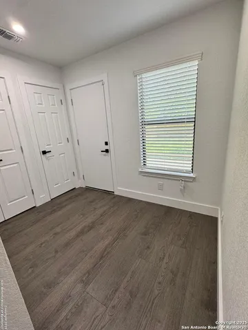 a view of a room with wooden floor