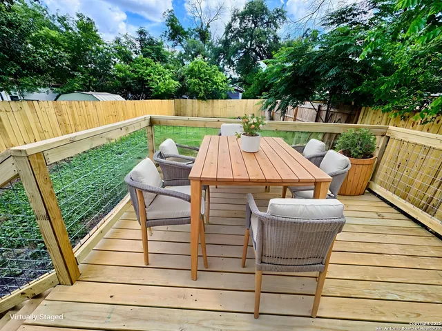 a view of deck with wooden floor and potted plants