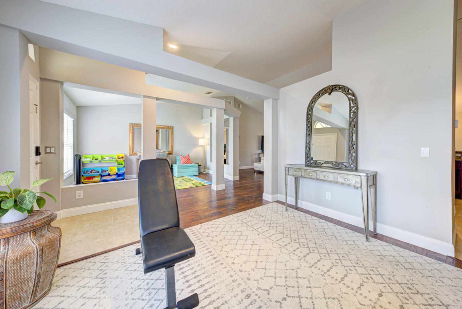 1029 Southwest Bay State Road Port St. Lucie, FL 34953 - Photo 12 of 39 a living room with furniture a mirror and a potted plant