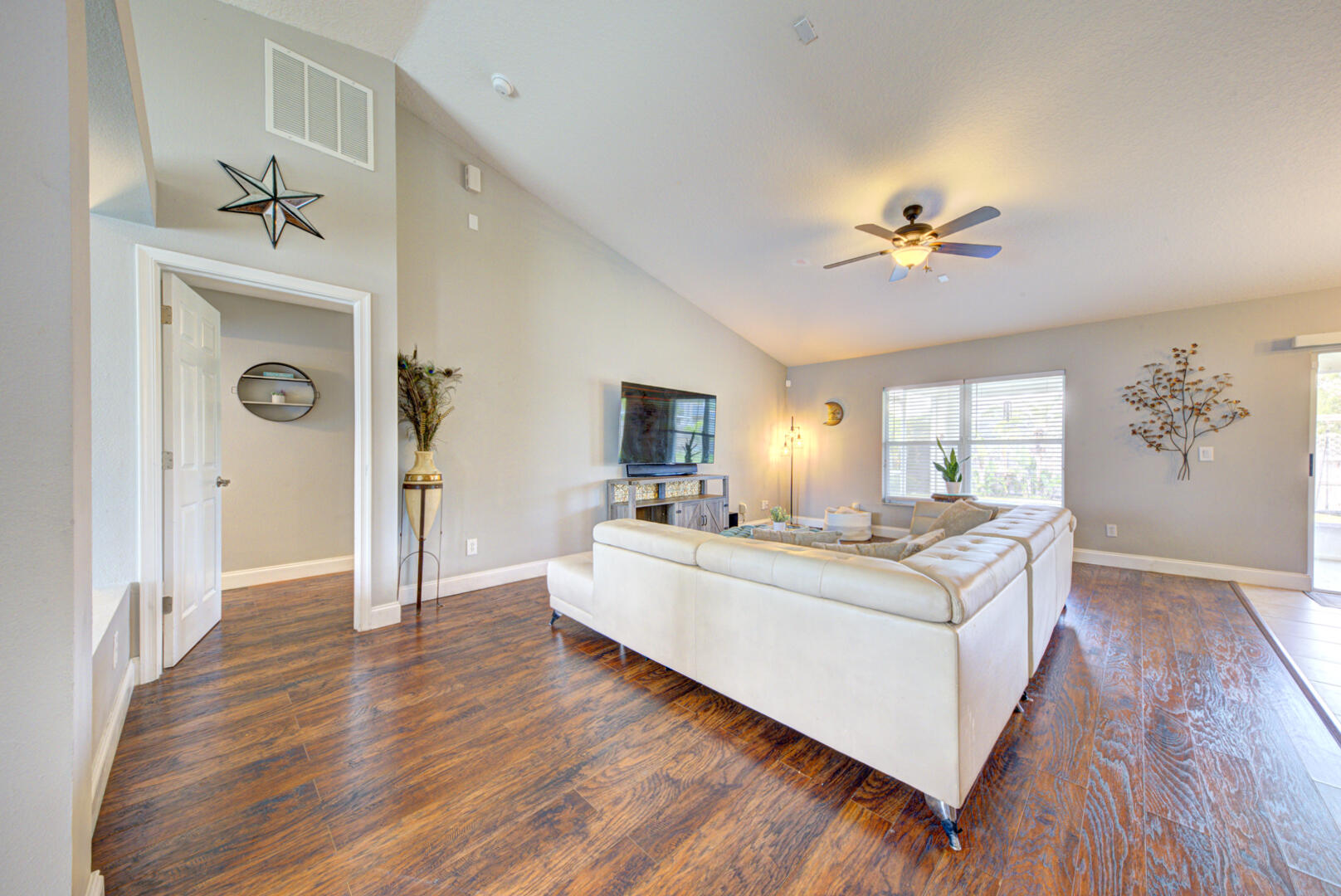 1029 Southwest Bay State Road Port St. Lucie, FL 34953 - Photo 14 of 39 a view of living room with kitchen island furniture and wooden floor