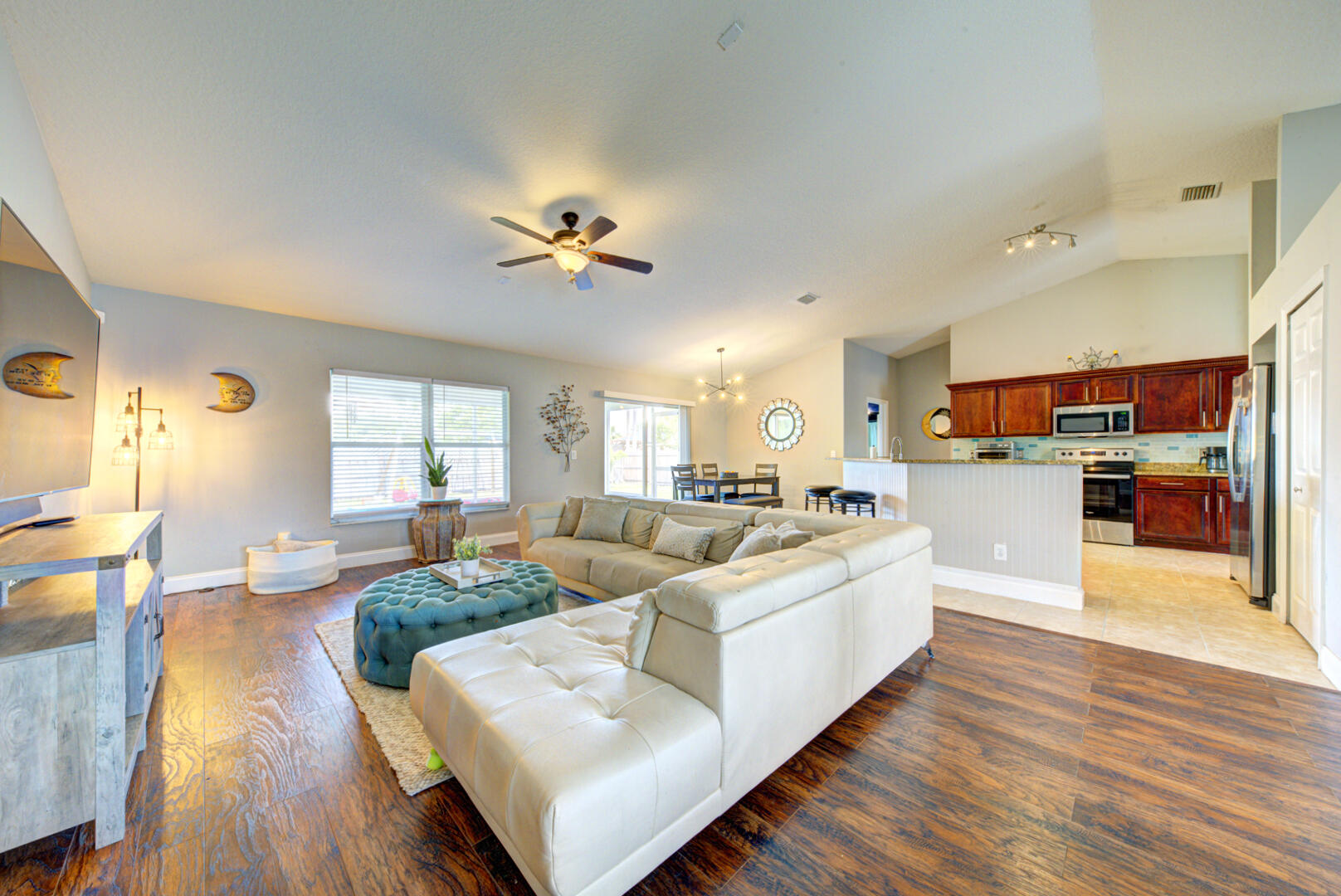 1029 Southwest Bay State Road Port St. Lucie, FL 34953 - Photo 16 of 39 a living room with furniture kitchen view and a wooden floor