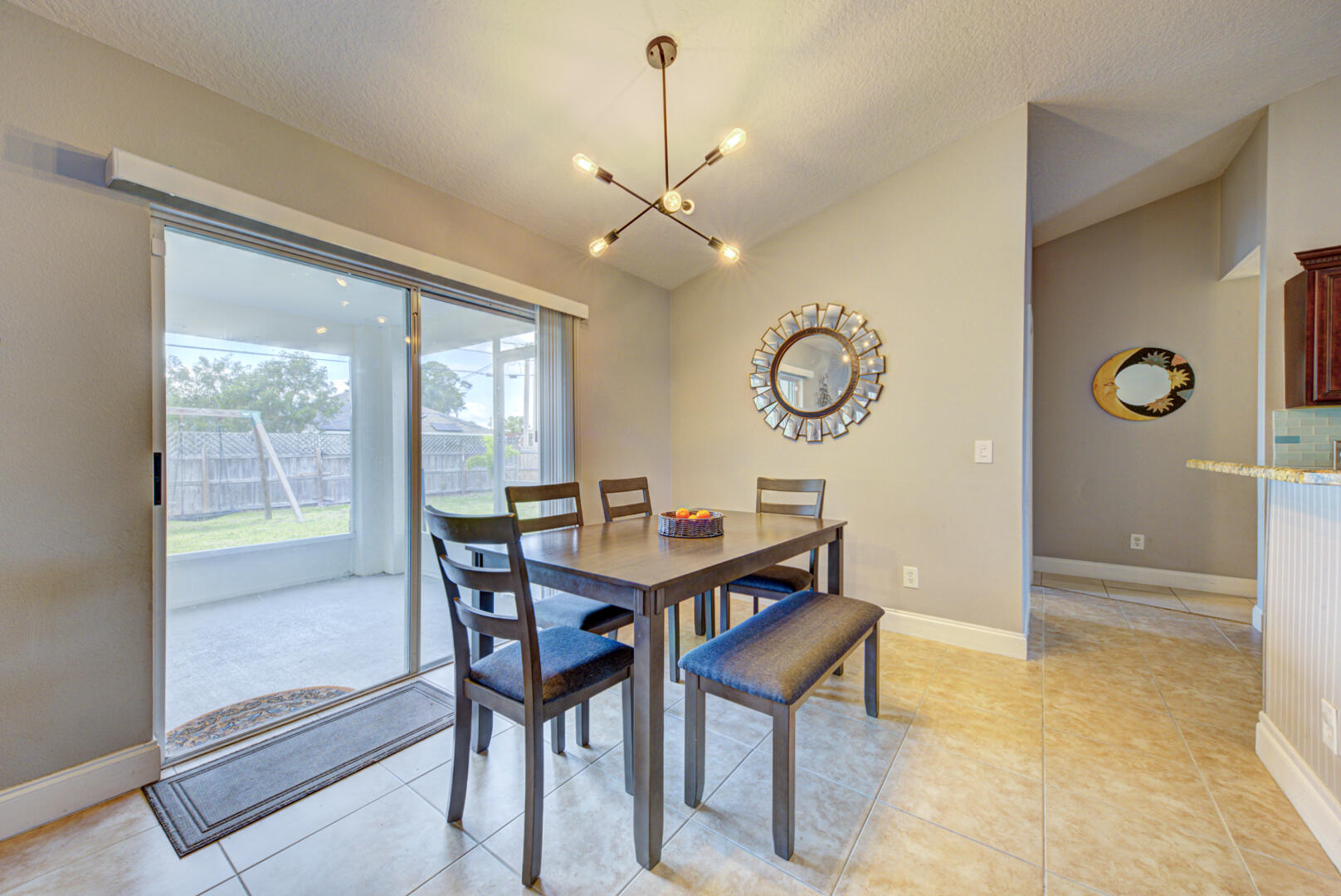 1029 Southwest Bay State Road Port St. Lucie, FL 34953 - Photo 18 of 39 a view of a dining room with furniture and wooden floor