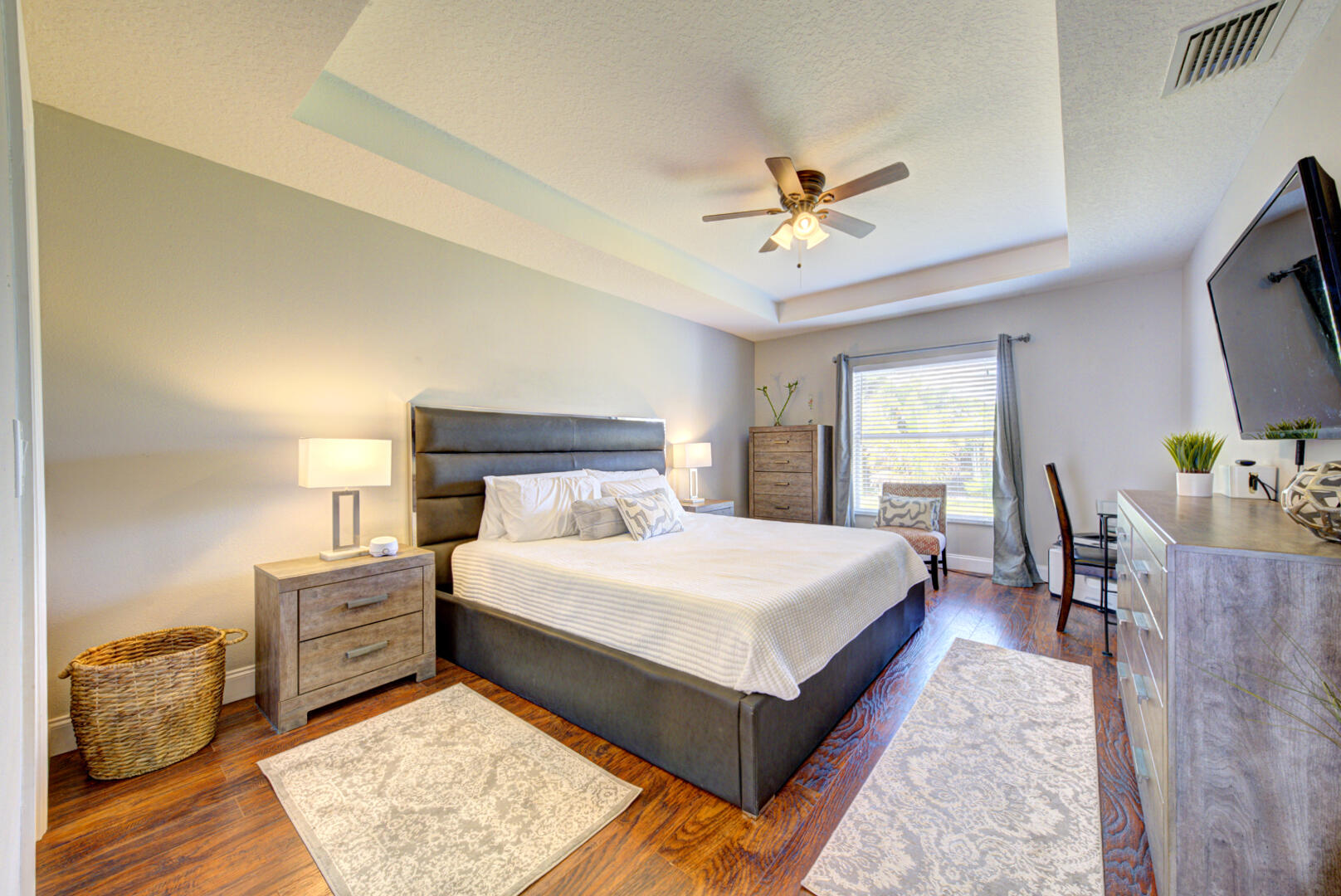 1029 Southwest Bay State Road Port St. Lucie, FL 34953 - Photo 25 of 39 a bedroom with a bed and a chandelier
