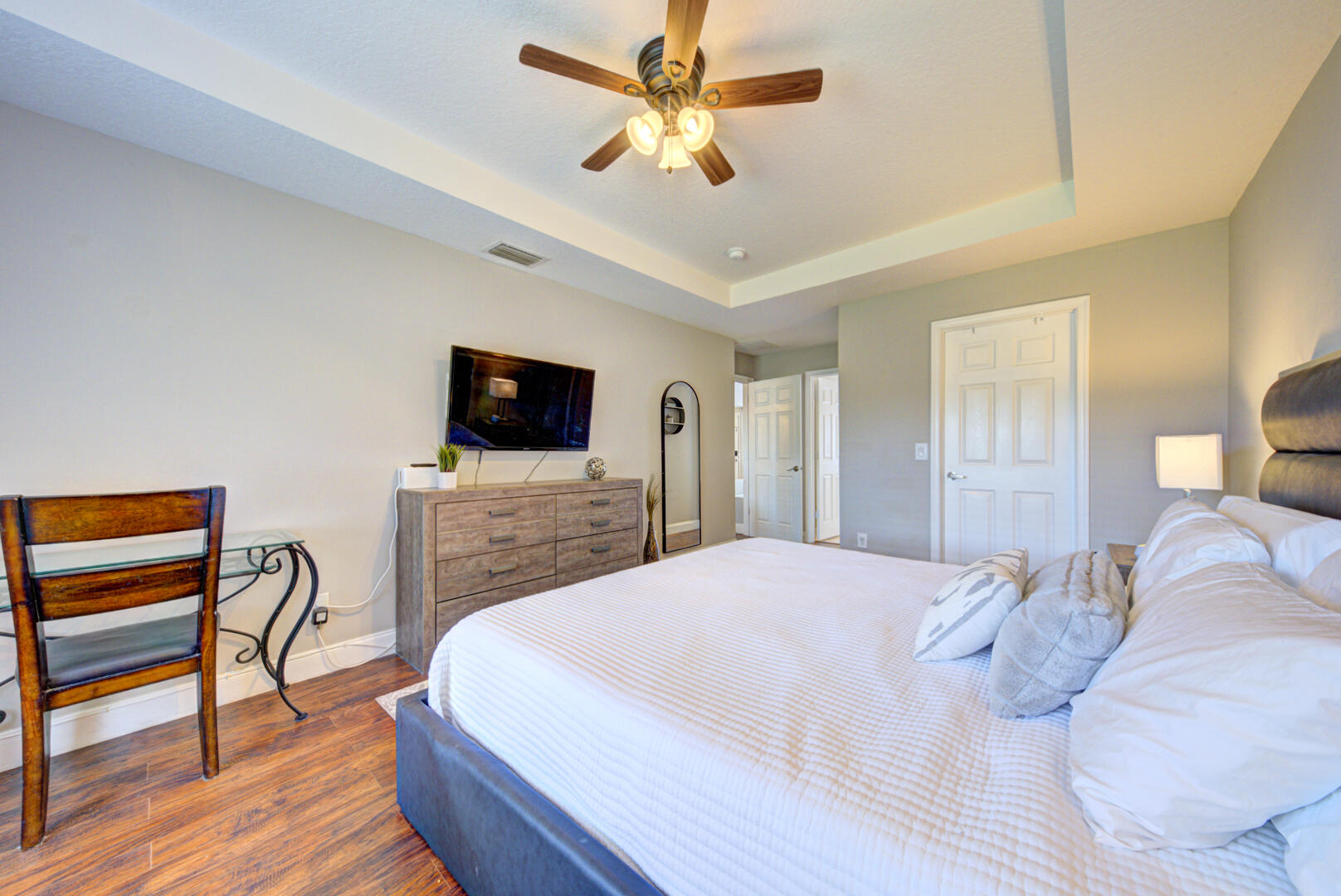 1029 Southwest Bay State Road Port St. Lucie, FL 34953 - Photo 26 of 39 a spacious bedroom with a bed and a flat screen tv