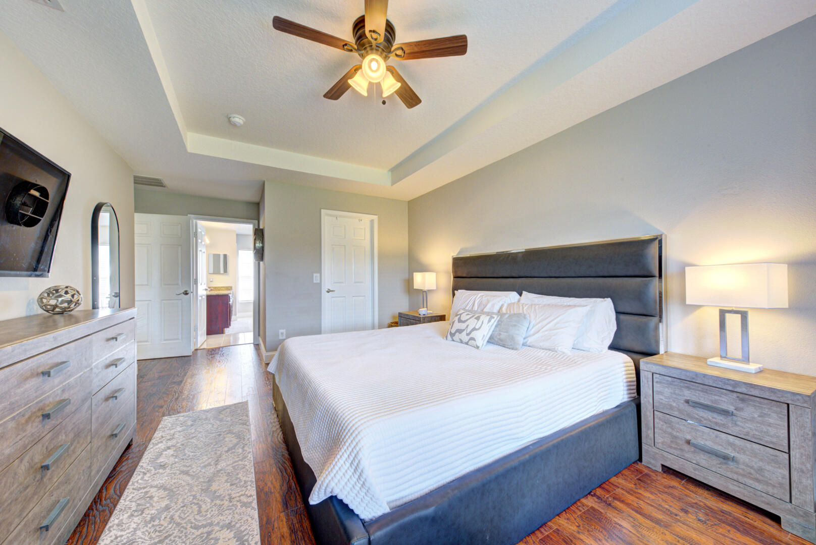 1029 Southwest Bay State Road Port St. Lucie, FL 34953 - Photo 27 of 39 a bedroom with a bed and a chandelier