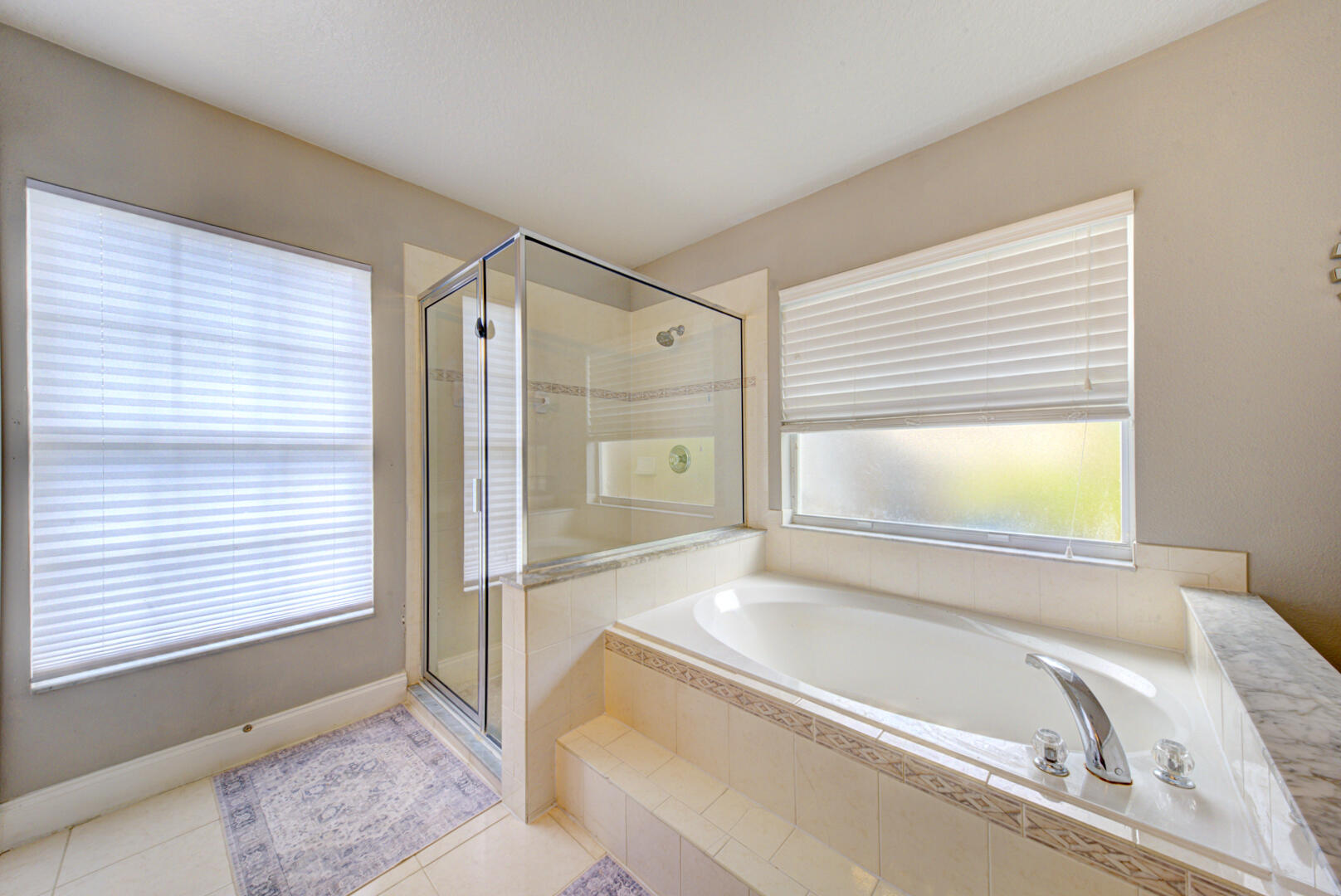 1029 Southwest Bay State Road Port St. Lucie, FL 34953 - Photo 28 of 39 a bathroom with a tub a sink and a window