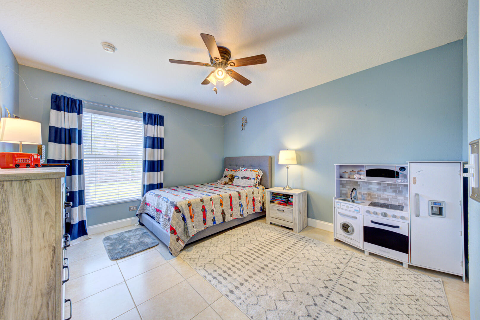 1029 Southwest Bay State Road Port St. Lucie, FL 34953 - Photo 30 of 39 a bedroom with a bed and a baby closet