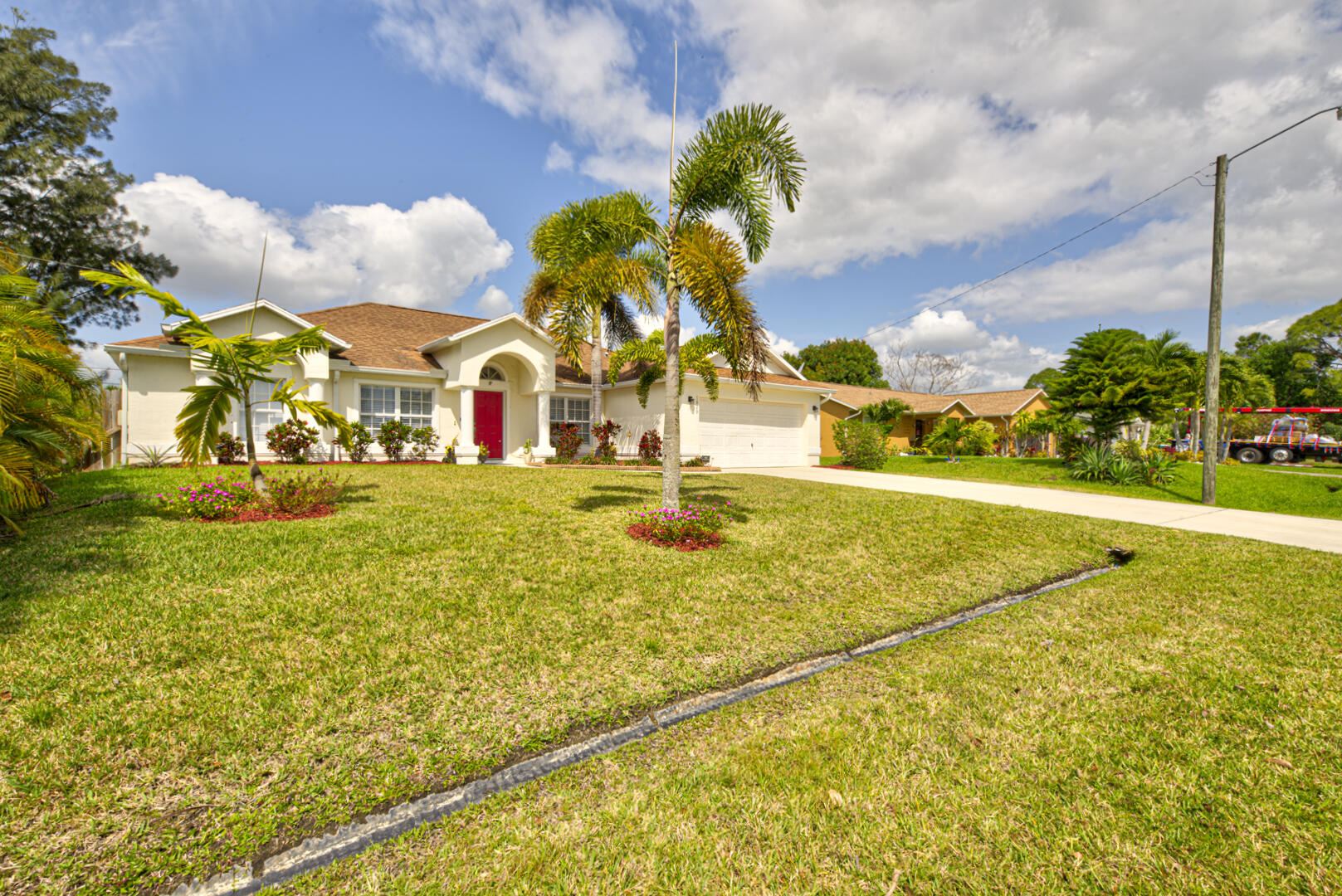 1029 Southwest Bay State Road Port St. Lucie, FL 34953 - Photo 3 of 39 a view of an swimming pool with a yard