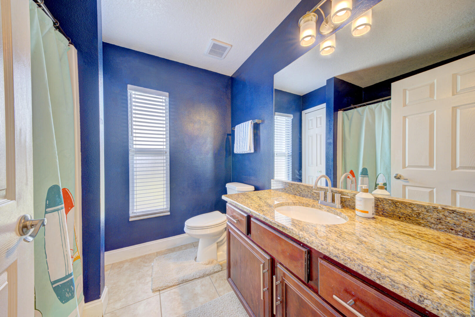 1029 Southwest Bay State Road Port St. Lucie, FL 34953 - Photo 32 of 39 a bathroom with a granite countertop sink and a mirror