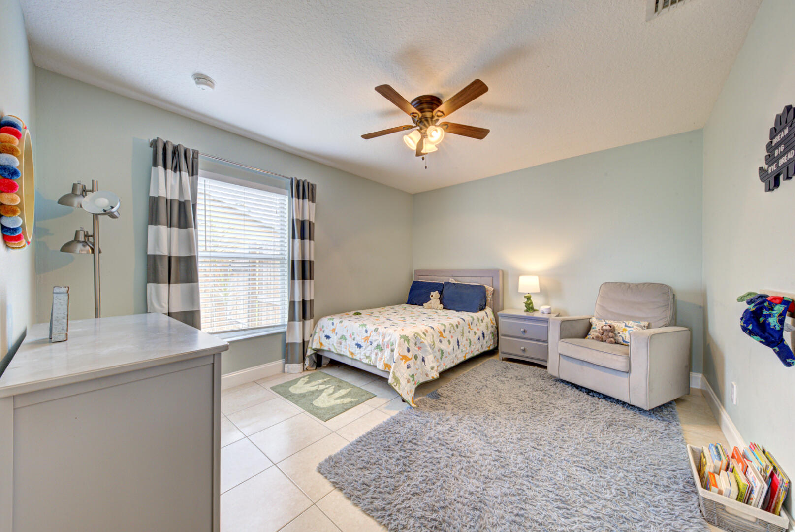 1029 Southwest Bay State Road Port St. Lucie, FL 34953 - Photo 33 of 39 a spacious bedroom with a bed and a couch