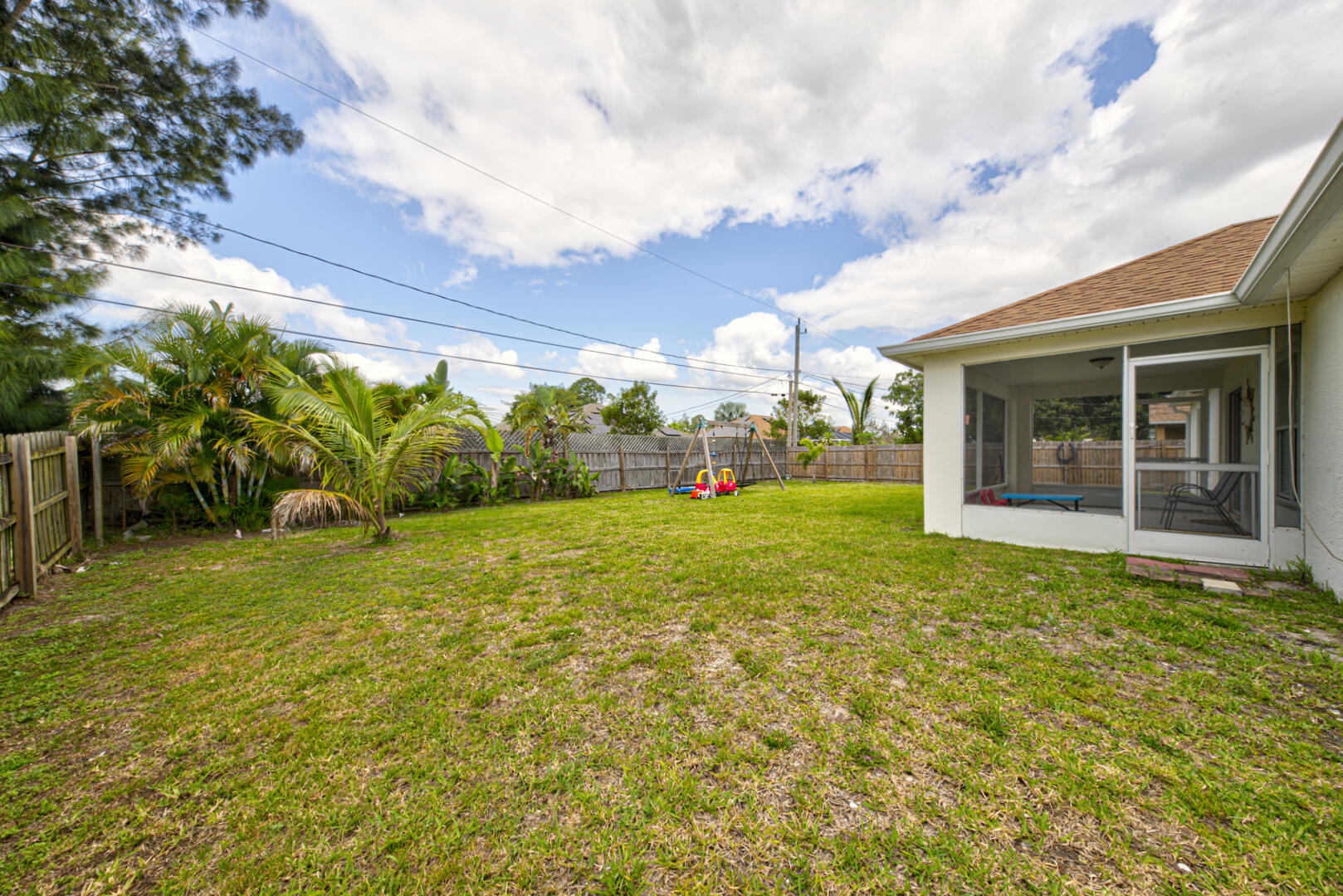 1029 Southwest Bay State Road Port St. Lucie, FL 34953 - Photo 37 of 39 a yellow house with garden in front of it