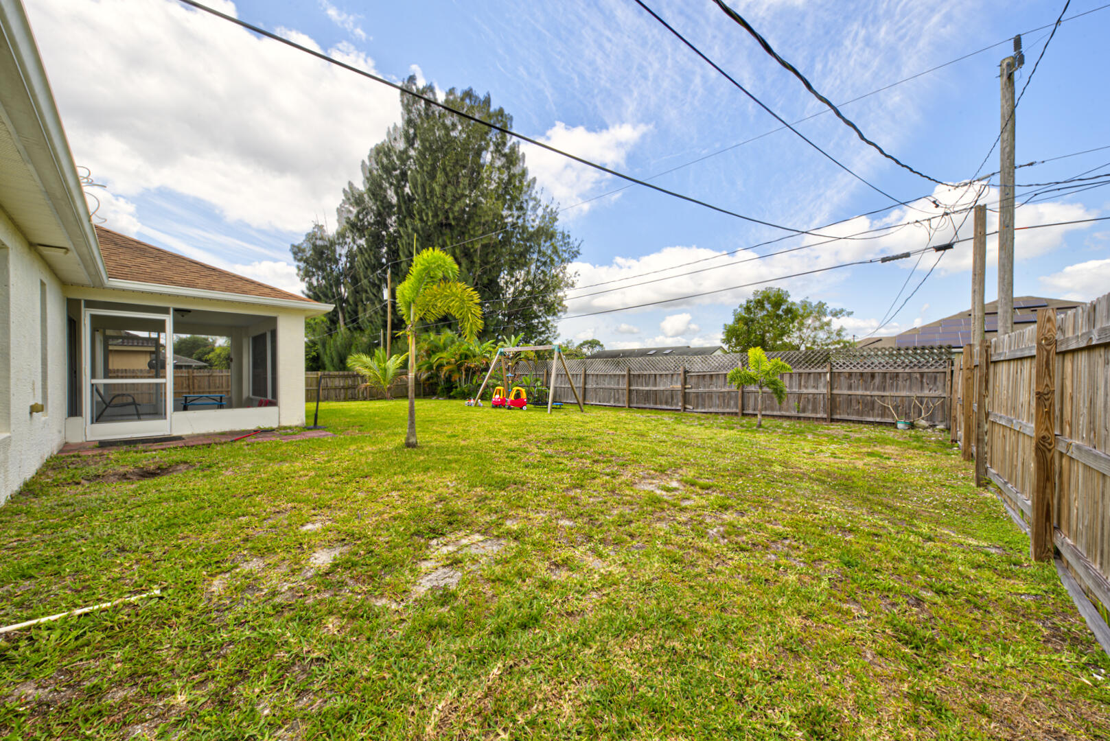 1029 Southwest Bay State Road Port St. Lucie, FL 34953 - Photo 38 of 39 a view of an house with backyard and a tree