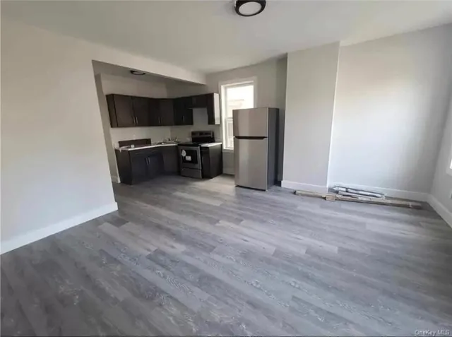 a kitchen with stainless steel appliances a refrigerator and a stove top oven