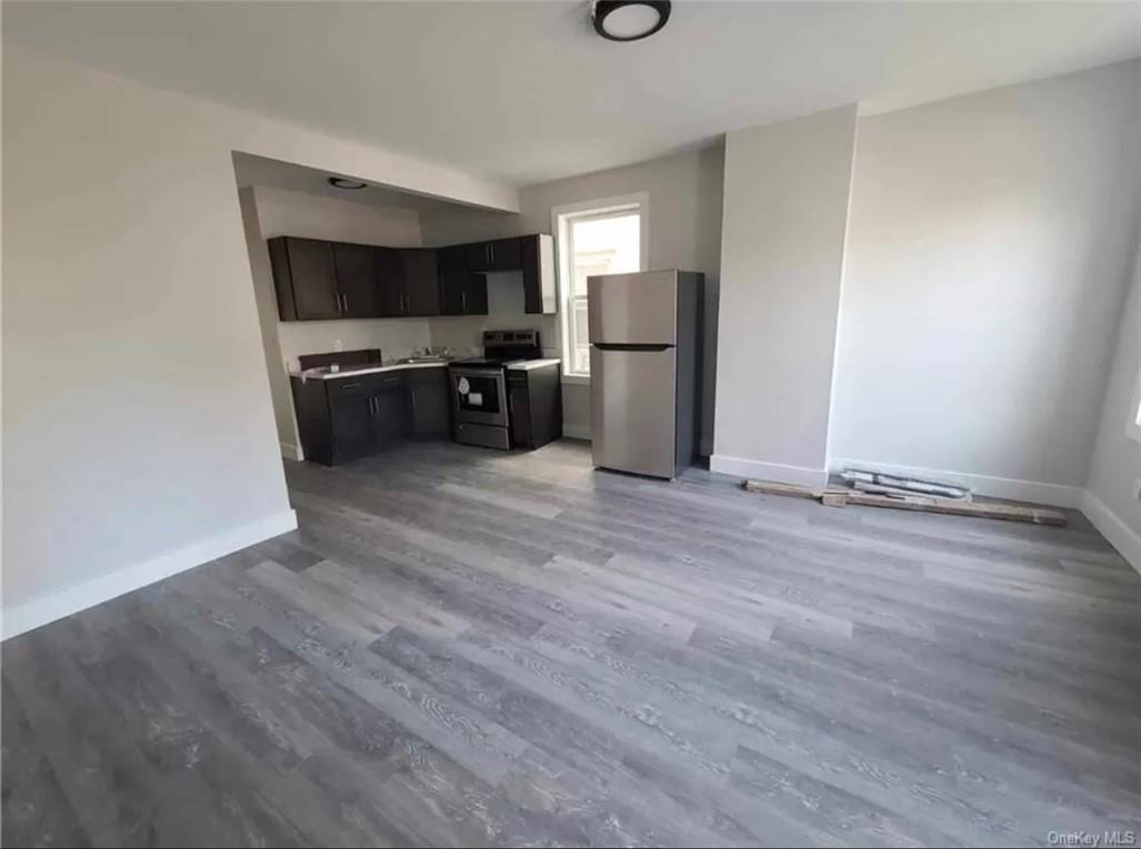 29 Hooker Avenue, Unit 2 Poughkeepsie, NY 12601 - Photo 3 of 9 a kitchen with stainless steel appliances a refrigerator and a stove top oven