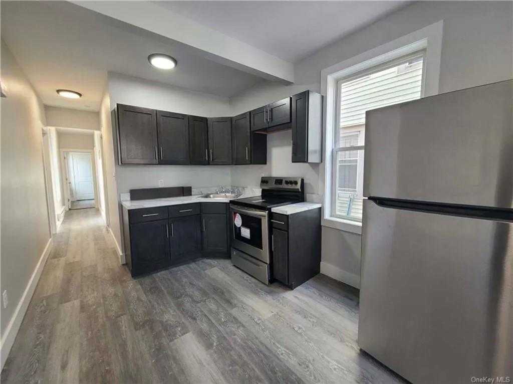 29 Hooker Avenue, Unit 2 Poughkeepsie, NY 12601 - Photo 4 of 9 a kitchen with stainless steel appliances granite countertop a refrigerator and a stove