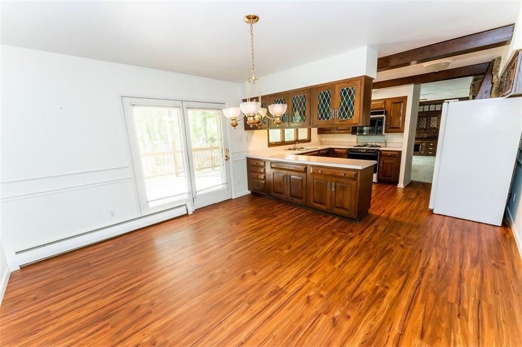 230 Nibert Road Indiana, PA 15701 - Photo 5 of 18 a kitchen with stainless steel appliances granite countertop a sink a stove a refrigerator cabinets and wooden floor