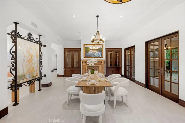 a living room with furniture a fireplace and chandelier