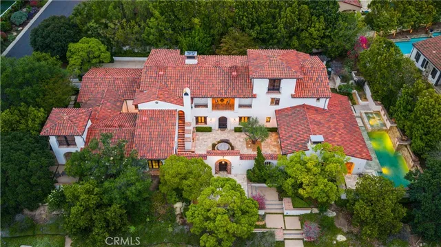 an aerial view of a house with garden space and a street view