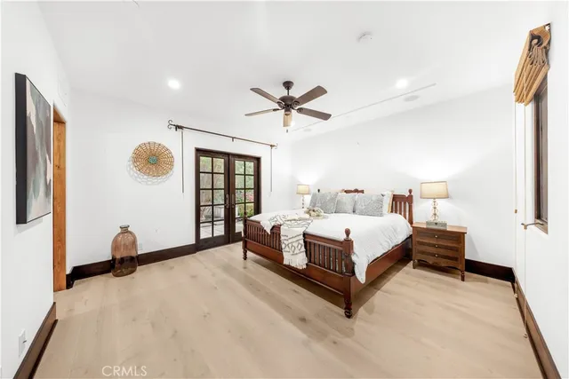 an aerial view of residential houses with outdoor space and trees
