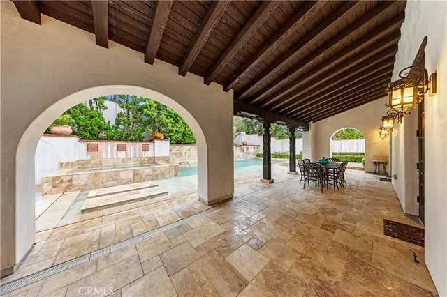 an aerial view of residential houses with outdoor space and trees