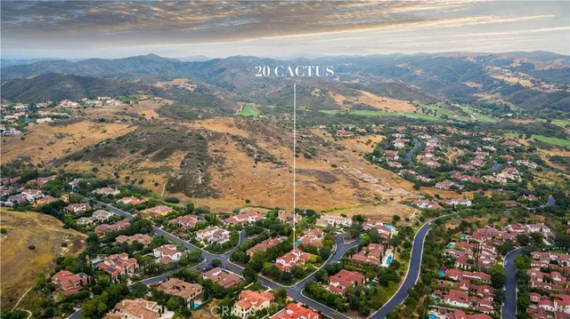 a view of a hallway with windows and chandelier