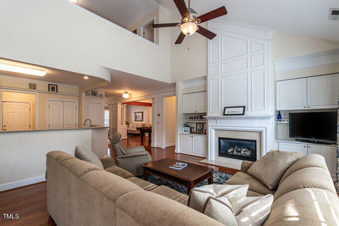 3742 Old Post Road Raleigh, NC 27612 - Photo 11 of 35 a living room with furniture a fireplace and a flat screen tv