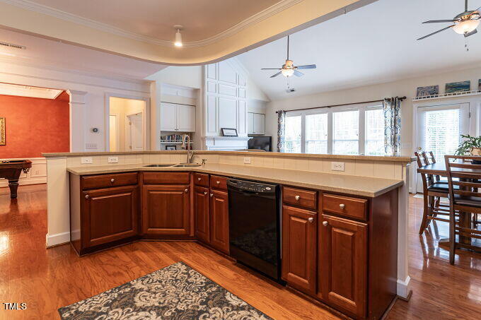 3742 Old Post Road Raleigh, NC 27612 - Photo 16 of 35 a kitchen with stainless steel appliances granite countertop wooden cabinets a sink a stove a dining table and chairs
