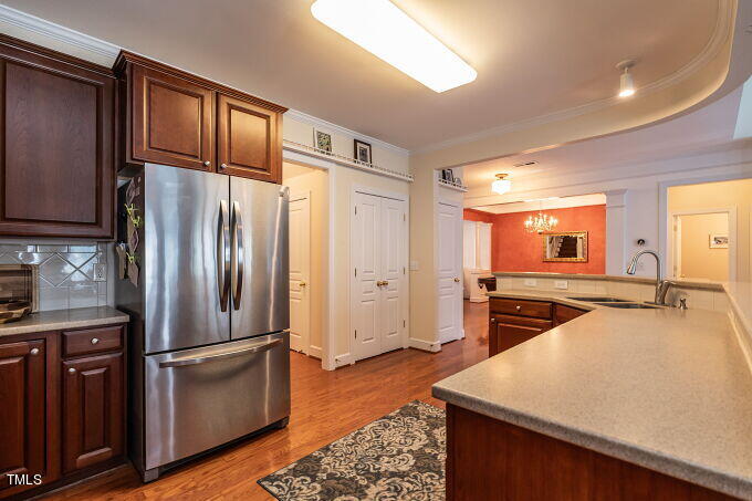 3742 Old Post Road Raleigh, NC 27612 - Photo 17 of 35 a kitchen with stainless steel appliances granite countertop a refrigerator a stove and a sink with wooden floor