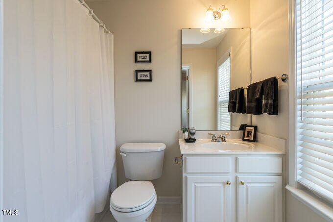 3742 Old Post Road Raleigh, NC 27612 - Photo 30 of 35 a bathroom with a toilet sink and mirror