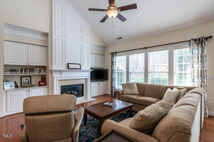 3742 Old Post Road Raleigh, NC 27612 - Photo 9 of 35 a living room with furniture a fireplace and a flat screen tv