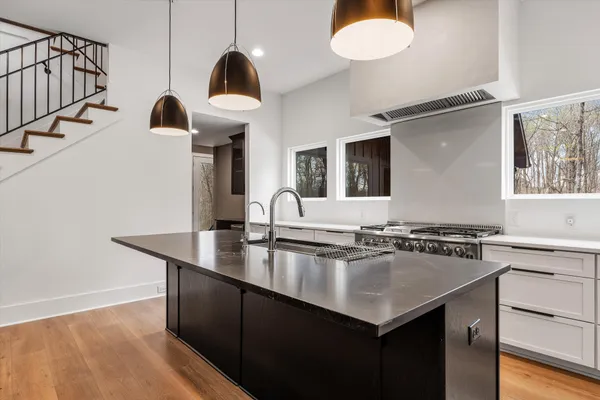 a kitchen with granite countertop a stove and a sink