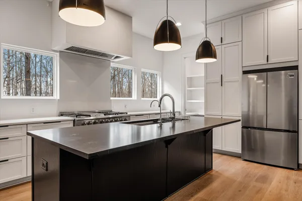 a kitchen with a refrigerator and a sink