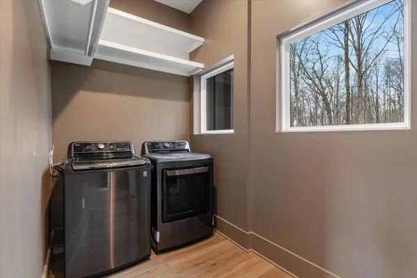 a view of a small space with wooden floor and a window