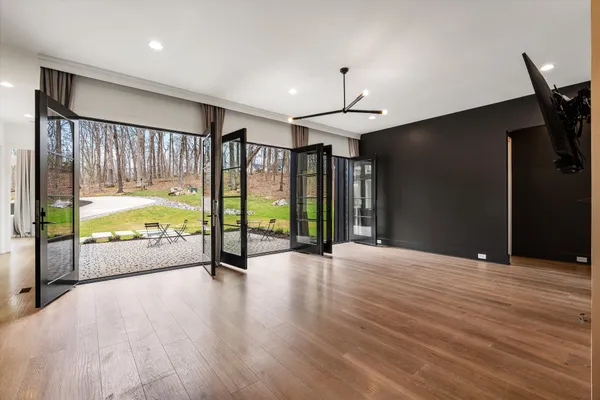 a kitchen with stainless steel appliances granite countertop a sink a stove and a wooden floors