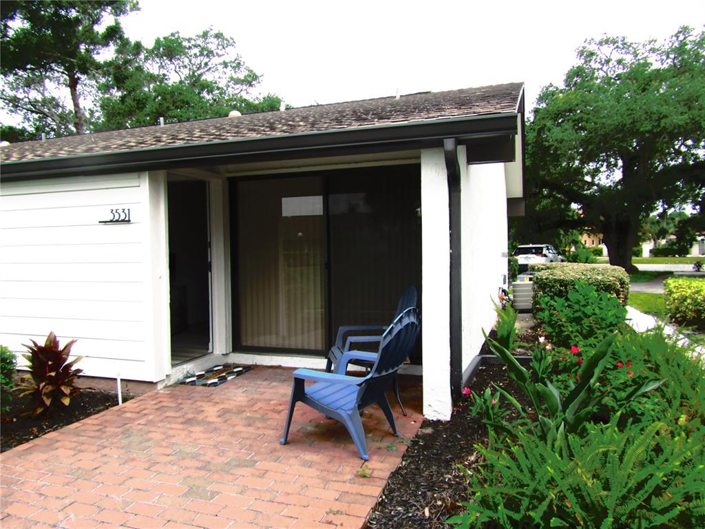 a view of backyard with a table and chairs and potted plants
