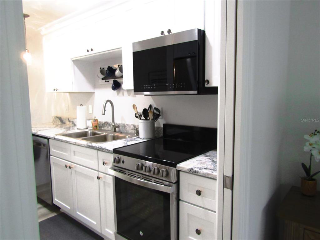 3531 Longmeadow, Unit 16 Sarasota, FL 34235 - Photo 13 of 29 a kitchen with a stove and a microwave