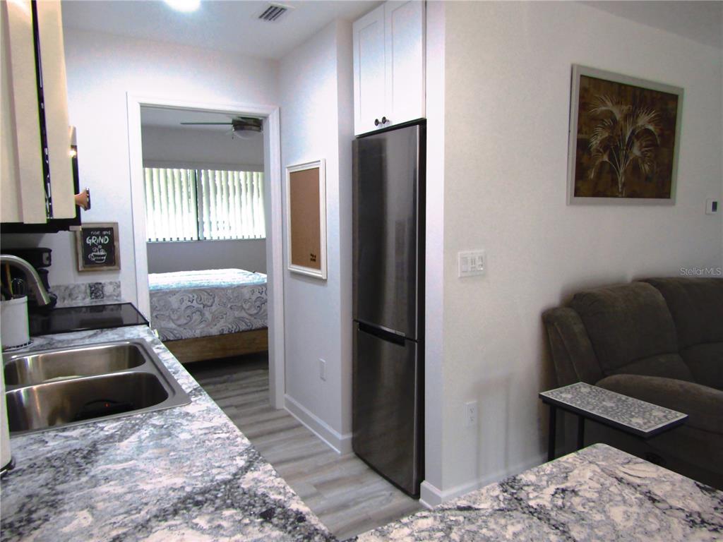 3531 Longmeadow, Unit 16 Sarasota, FL 34235 - Photo 15 of 29 a bedroom with bed and furniture