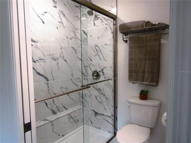 a bathroom with a toilet and shower