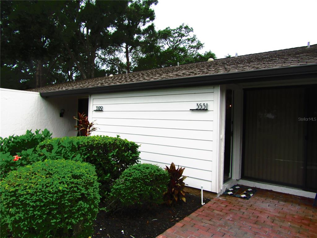 3531 Longmeadow, Unit 16 Sarasota, FL 34235 - Photo 2 of 29 a backyard of a house with lots of green space