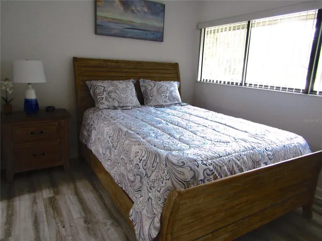 a bed sitting in a bedroom next to a window