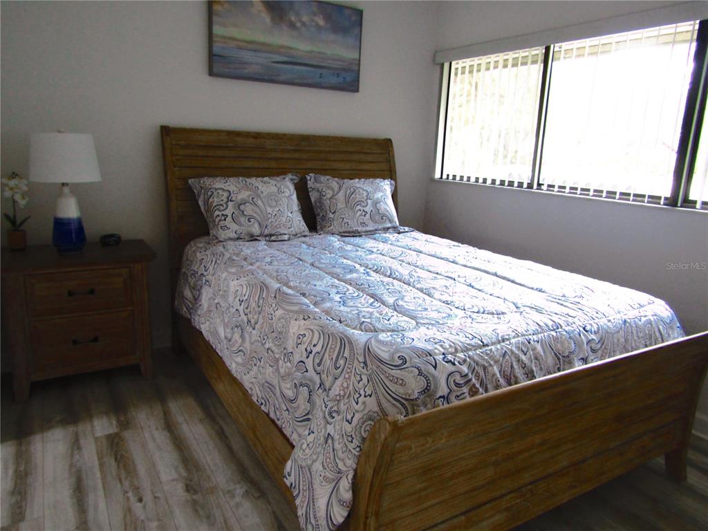 3531 Longmeadow, Unit 16 Sarasota, FL 34235 - Photo 21 of 29 a bed sitting in a bedroom next to a window