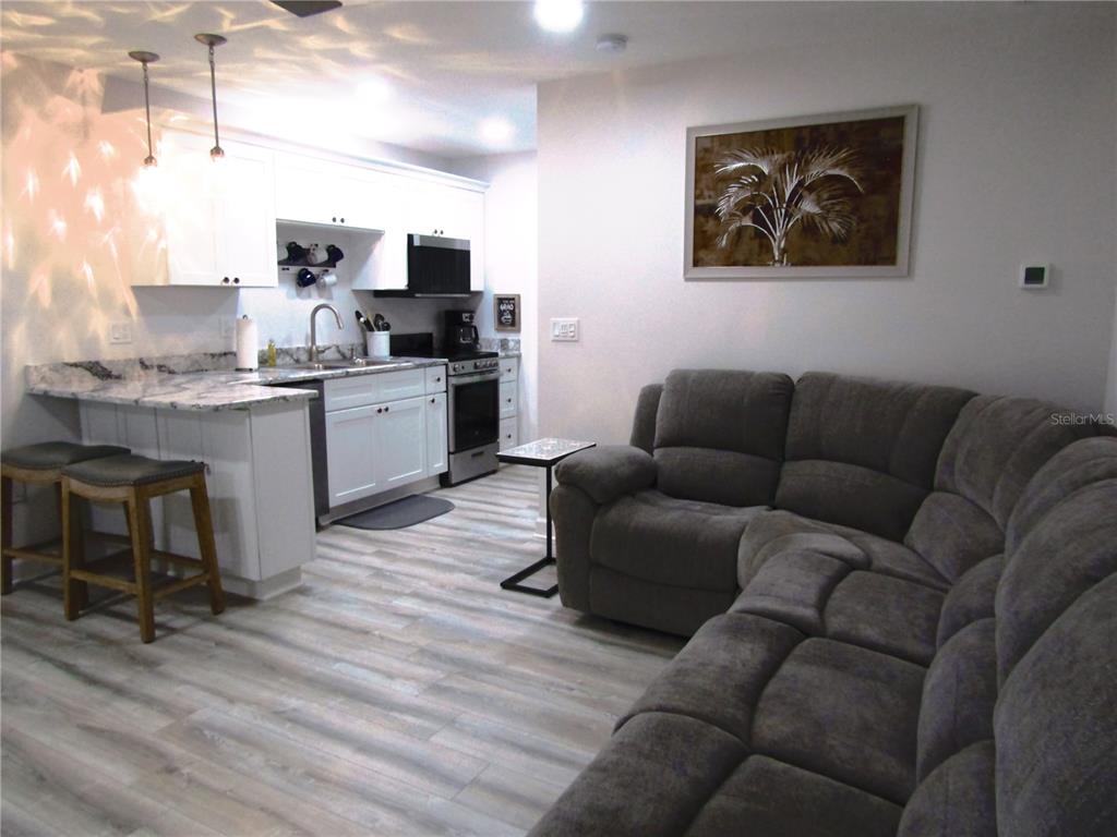 3531 Longmeadow, Unit 16 Sarasota, FL 34235 - Photo 24 of 29 a living room with furniture and kitchen view