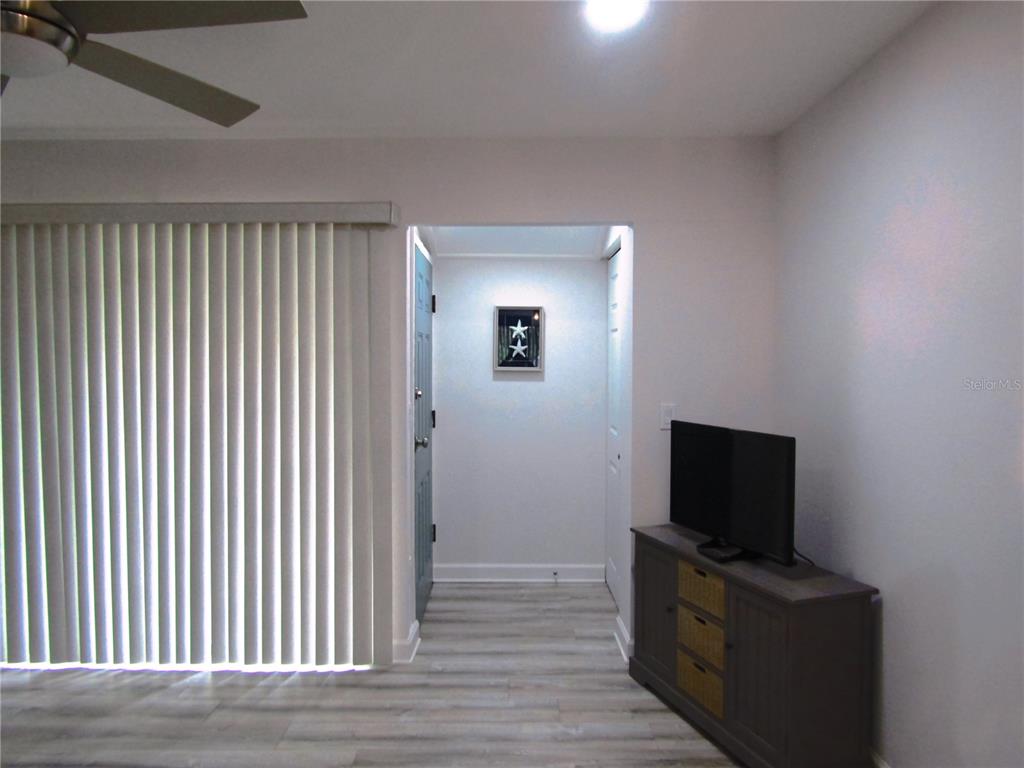 3531 Longmeadow, Unit 16 Sarasota, FL 34235 - Photo 27 of 29 a view of a livingroom with an empty space and a flat screen tv