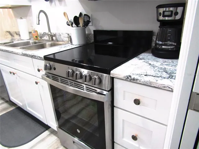 a close view of a stove a microwave and cabinets